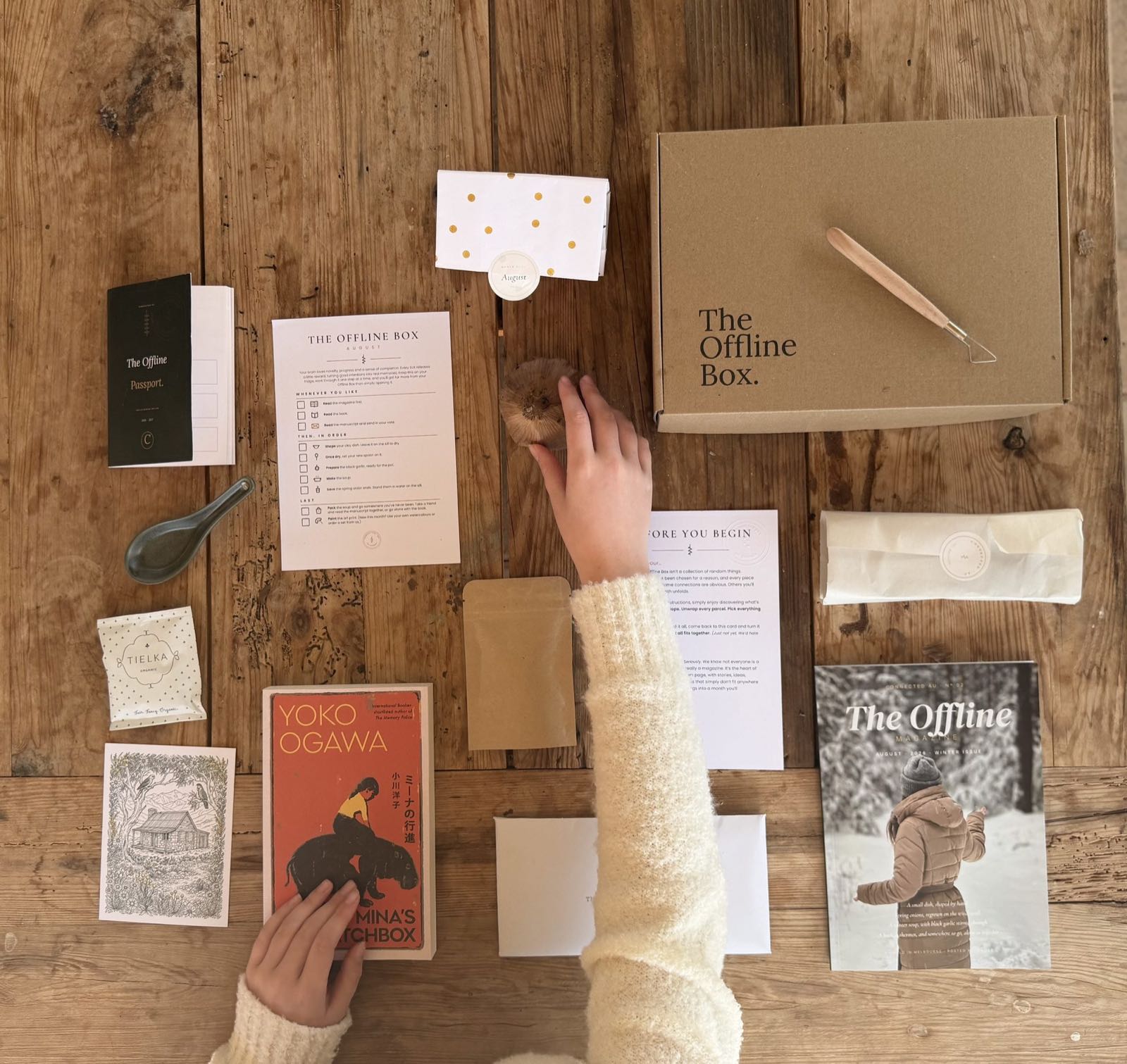 The August Offline Box laid out on a timber table