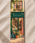 A MERRI illustrated bookmark showing the MERRI Books shopfront with a bicycle and flowers