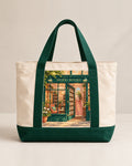 The MERRI Book Tote in cream canvas with forest green handles and the MERRI Books shopfront print