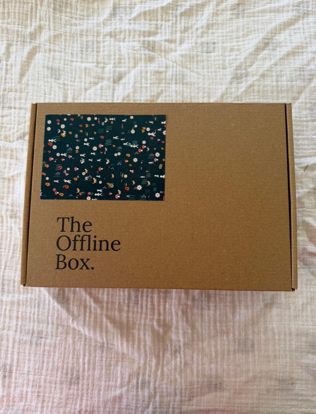 The Offline Box on a bed, ready to open