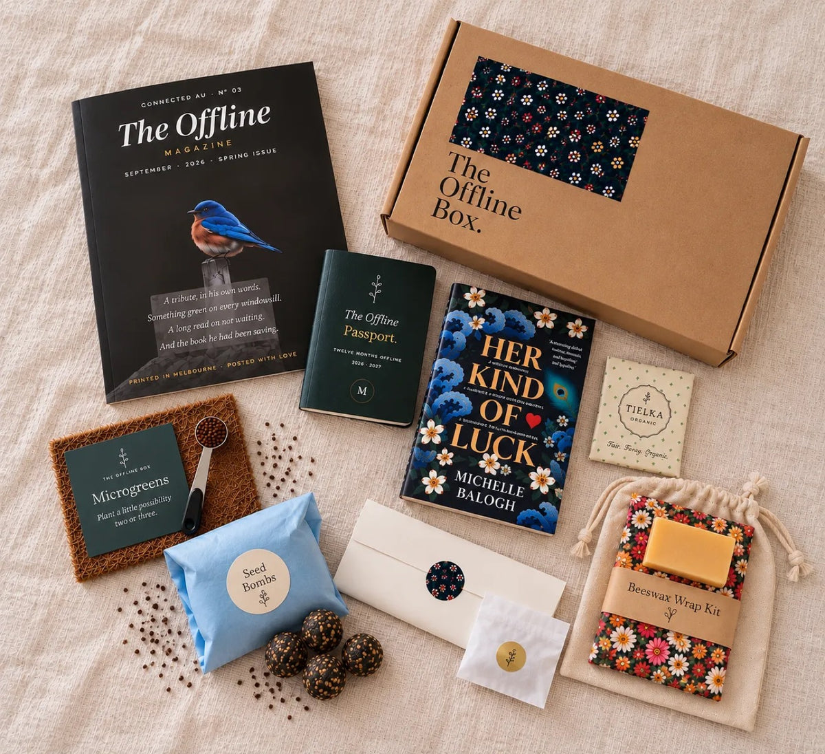 Everything in a recent Offline Box laid out on linen