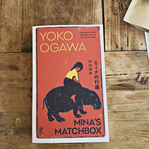 A novel from a past Offline Box resting on a linen cloth