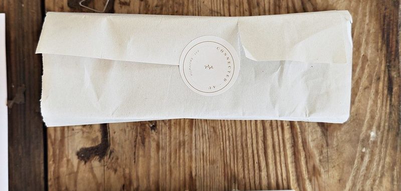 An Offline Box wrapped in tissue and sealed by hand, ready to post